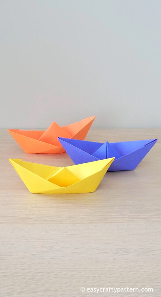 Blue, yellow, and orange paper boat