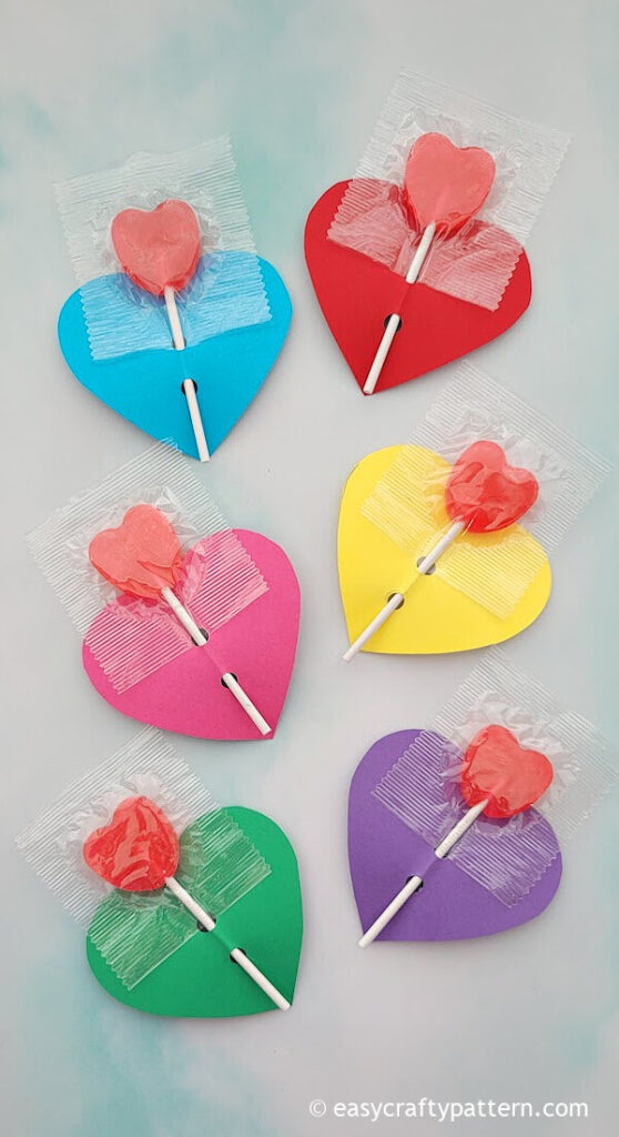 Colourful heart paper with lollipop.
