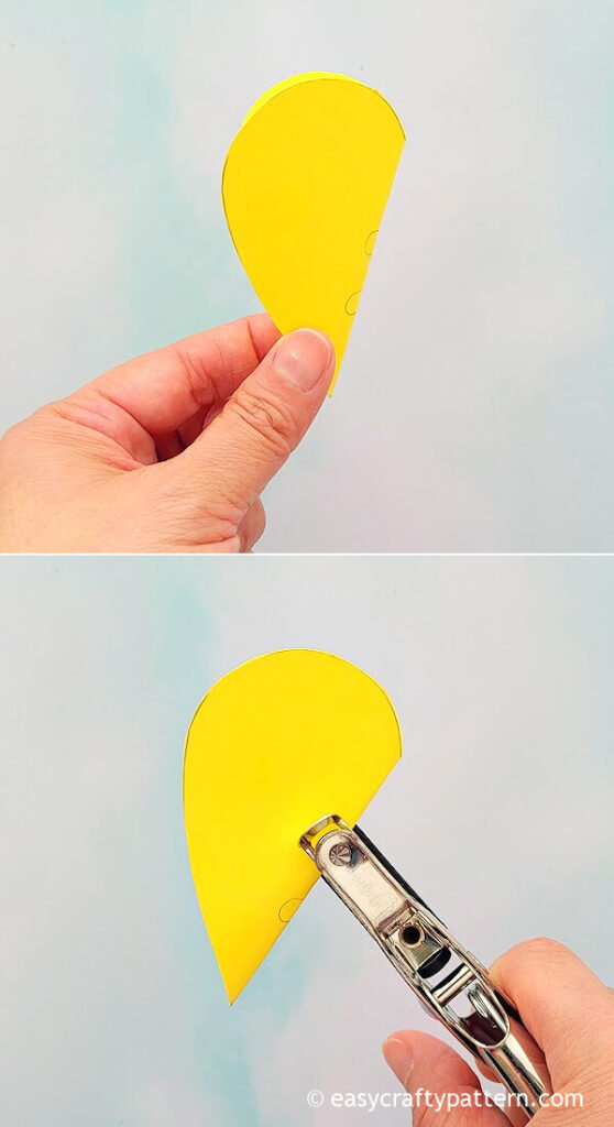 Hole puncher on yellow paper.