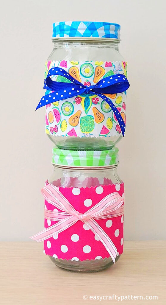 Mason jars with pink fabric and ribbon.