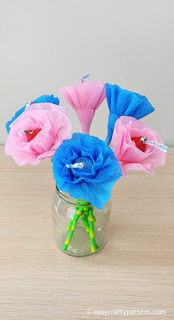 Pink and blue paper flower chocolate on jar.