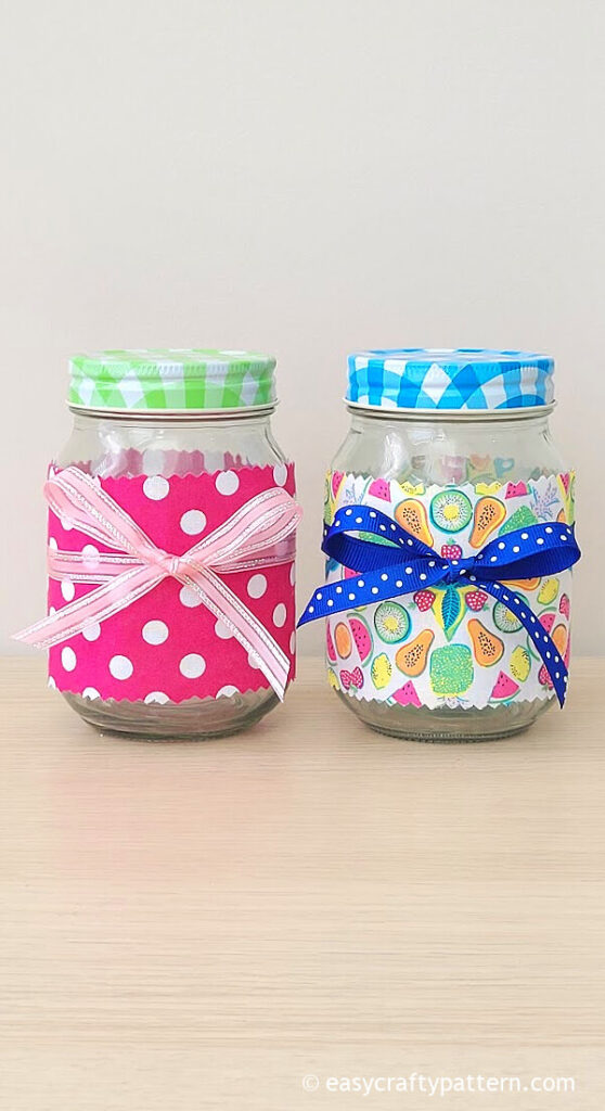 Two mason jars wrapped with fabric.