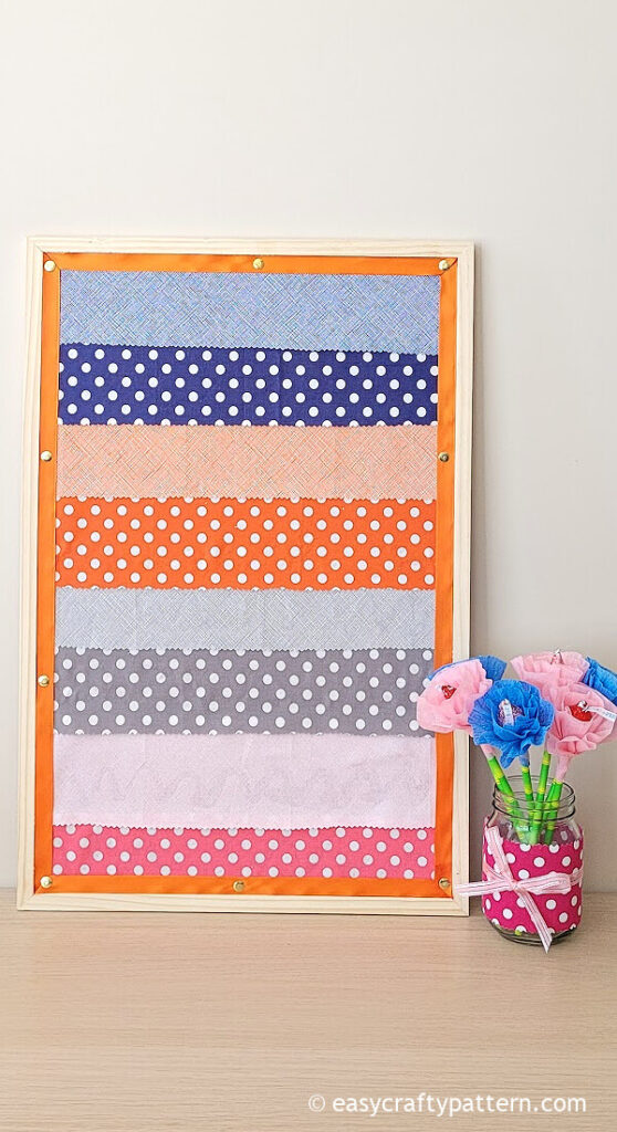 Bulletin board with colourful fabric.