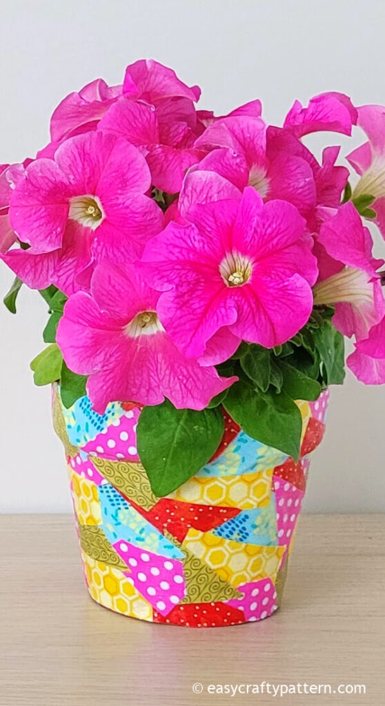 Pink petunia on decorated clay pot.