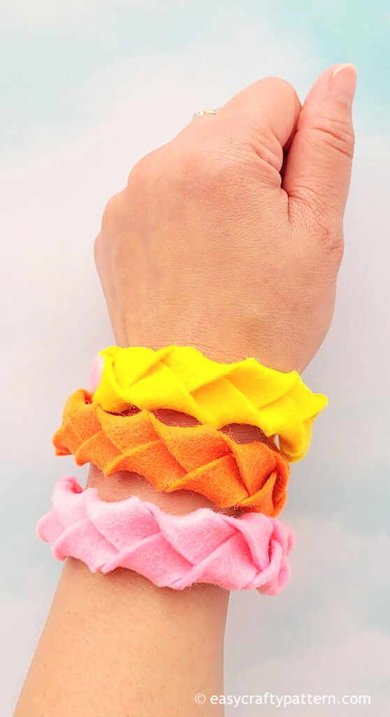 Yellow, pink, and orange felt bracelets.
