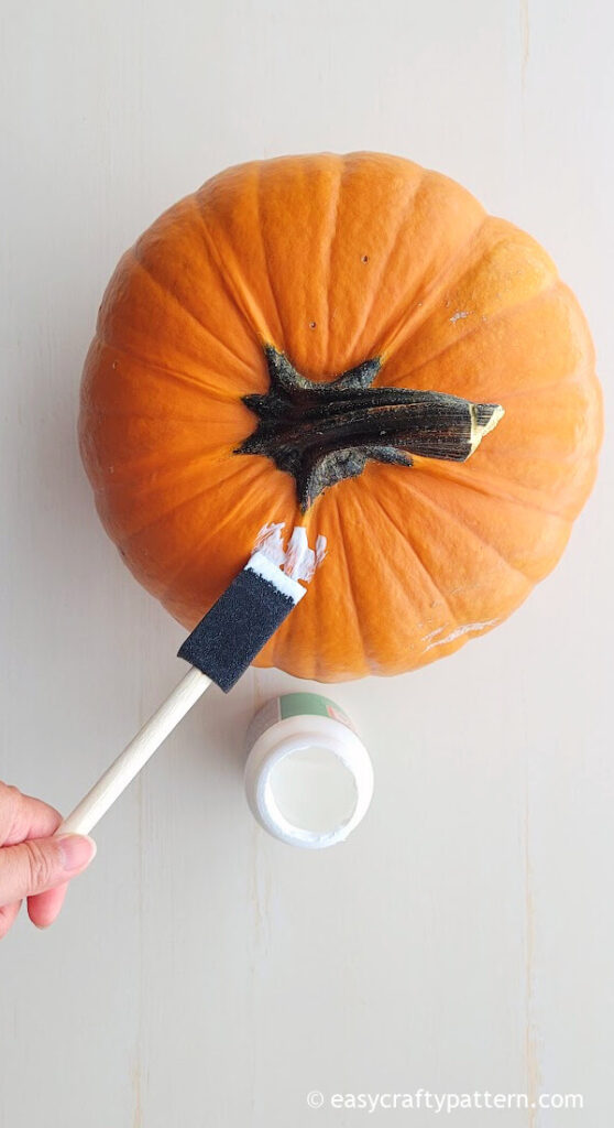 Applying glue on real pumpkin.