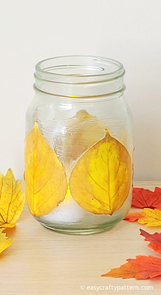 Mason jar with glued leaf.