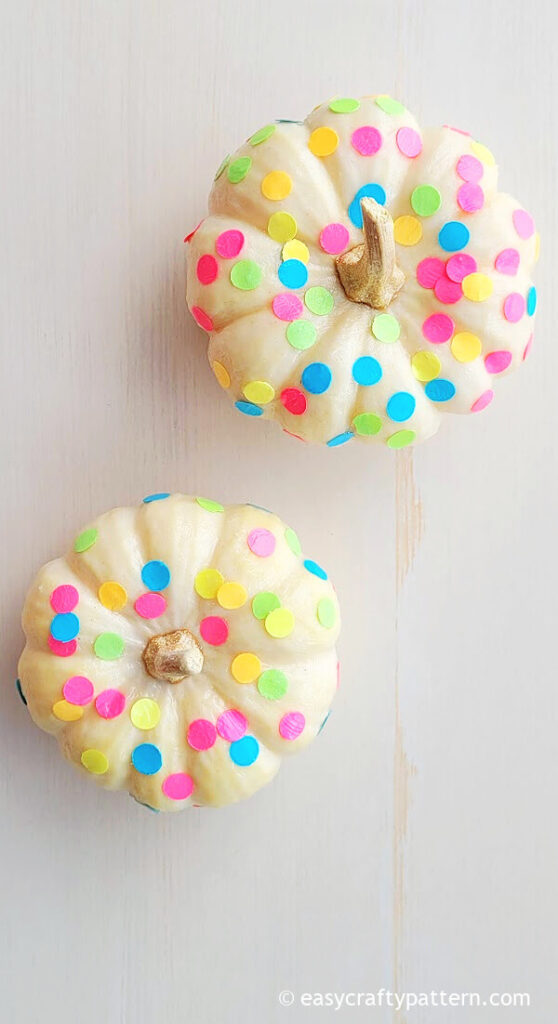 Two pumpkins with colourful confetti.